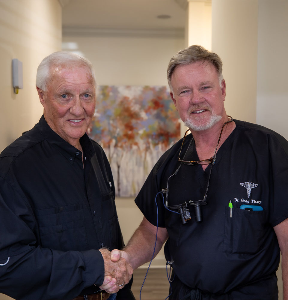 dr. tharp shakes hand with dental patient