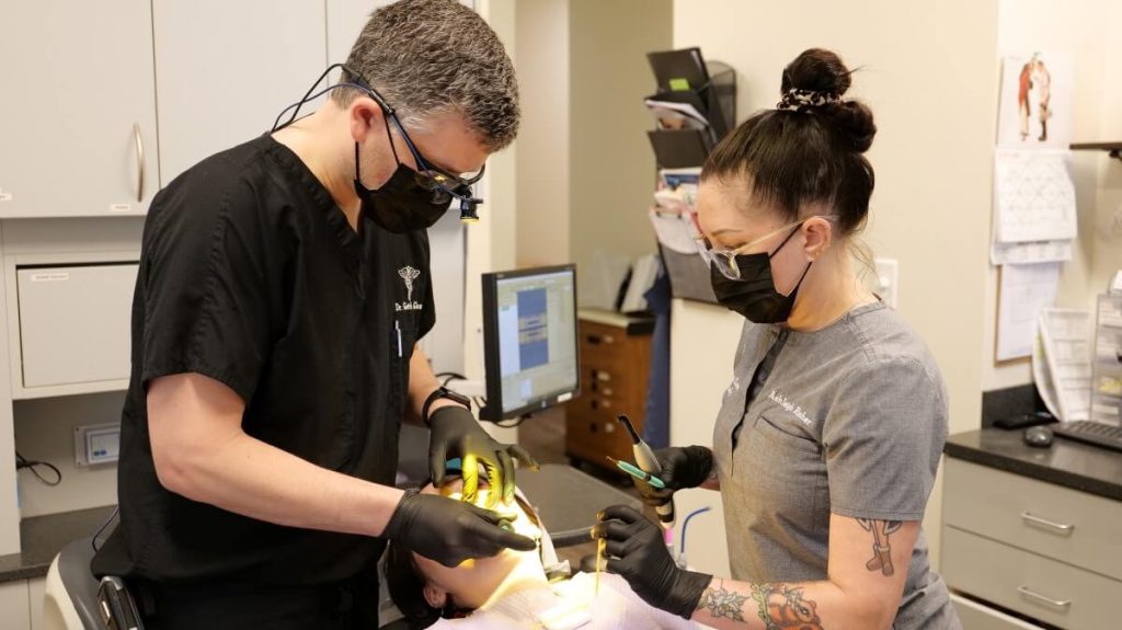 dentist and assistant working on patient