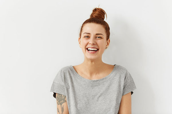 woman smiling, showing off natural-looking teeth